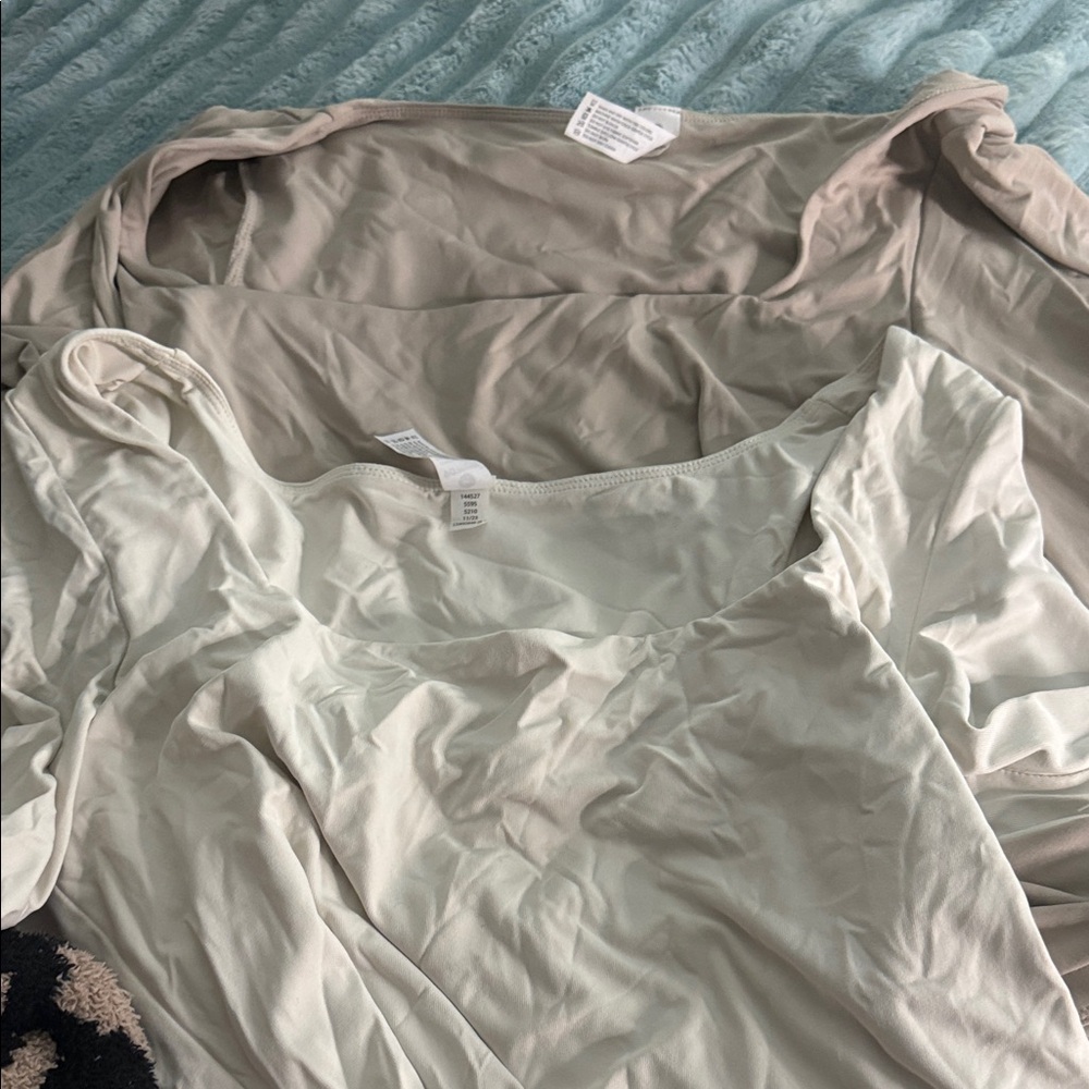 Two long sleeve cream shirts